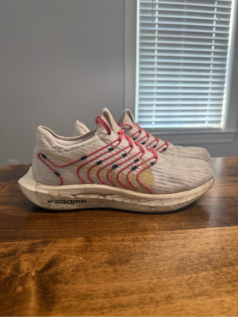 Nike Women’s Running Sneakers in Off-White with Coral and Yellow/Golden Accents